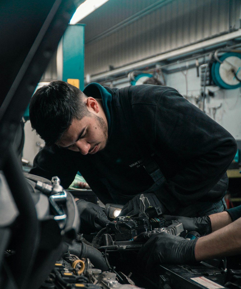 Interior of a clean, modern auto repair shop with cars on hydraulic lifts and organized tool chests